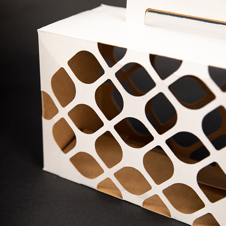 White die-cut custom packaging structure with geometric cutout pattern