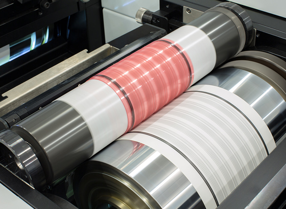 Flexography press with red and white patterned printing cylinders