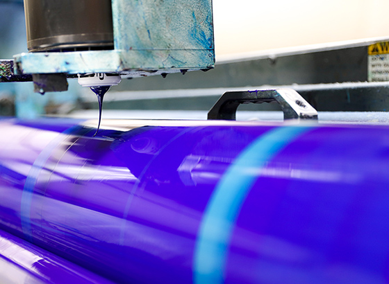 Close-up of a lithography offset printing press with vibrant blue ink roller