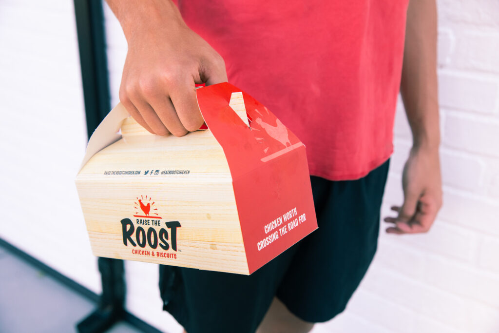 Person holding a custom printed carry box