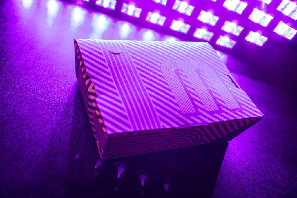 Custom printed box with purple line design all around and branded top