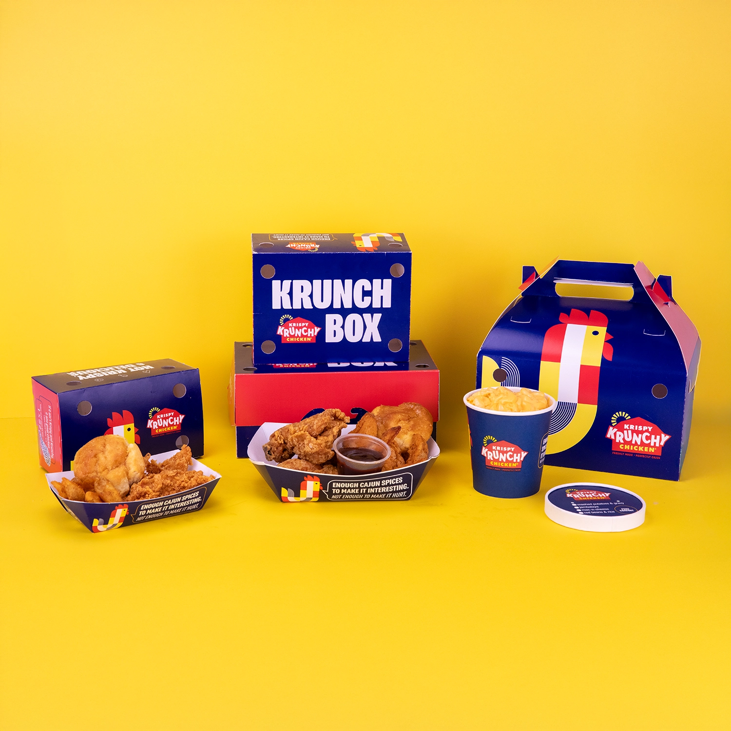 Brightly colored display of various custom designed food containers for Krispy Krunchy Chicken.